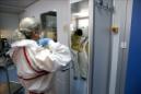 Con motivo del primer aniversario de la llegada a España de un paciente infectado con ébola, el Instituto de Salud Carlos III abre por primera vez las puertas de su laboratorio de alta seguridad P-3 a los medios. En la foto, una investigadora se coloca el traje y la máscara de seguridad antes de entrar en el laboratorio. EFE
