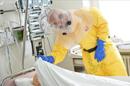 Un sanitario viste un traje especial para tratar a un paciente de Ébola. EFE/Archivo