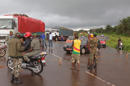 En esta foto del 12 de agosto de 2014, soldados de Guinea rodean una cuerda en el camino que separa Guinea de Sierra Leona y sirve de retén fronterizo improvisado en Gbalamuya-Pamelap, Guinea.(AP Foto/ Youssouf Bah)