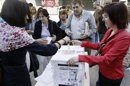 Varias personas depositan su voto sobre la consulta popular que han organizado asociaciones sanitarias y diversos colectivos ciudadanos para conocer en qué medida los madrileños están de acuerdo con la externalización de seis hospitales de Madrid. EFE/Archivo