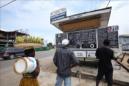 Varias personas leen unas instrucciones sobre el Ébola en una calle de Monrovia, Liberia, el pasado 10 de julio. EFE/Archivo